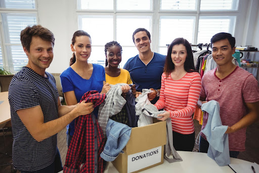 Employees donating canned foods for Giving Tuesday for employee wellness