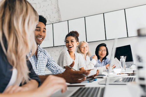 Happy employees smiling at a conference table