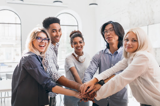 Employees gathering hands to celebrate